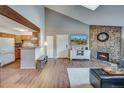 A spacious living room features a stone fireplace, wood beam accent, and adjoins an eat-in kitchen at 3325 S Ammons St # 4-206, Lakewood, CO 80227