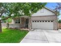 Inviting brick home featuring a covered porch, attached two-car garage, and neat landscaping at 7171 Canyon Way, Frederick, CO 80504