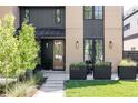 Close up on the front exterior of the home, featuring a wood front door and manicured yard at 3934 Kalamath St, Denver, CO 80211