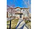 Inviting two-story home featuring a secure, gated yard and a charming front patio area at 2525 S Pennsylvania St, Denver, CO 80210