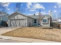 Charming single-story home with neutral siding, two-car garage, and minimal front yard landscaping at 19739 E Wagontrail Dr, Centennial, CO 80015