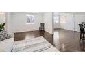 Spacious living room with hardwood floors, bright white walls, and a minimalist aesthetic at 5951 Oneida St, Commerce City, CO 80022