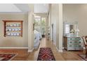 Inviting foyer with high ceilings, hardwood floors, and decorative display case at 11615 E Maplewood Ave, Englewood, CO 80111