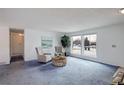 Inviting living room featuring comfortable seating, a large window with natural light, and neutral decor at 11644 Jackson St, Thornton, CO 80233