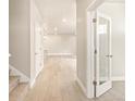 Light and bright hallway with light wood floors and carpet at 8115 Mt Harvard Rd, Littleton, CO 80125