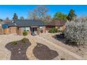 Aerial view of brick homes with low maintenance landscaping and mature shade trees at 3011 Oneida St, Denver, CO 80207
