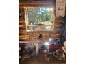Bright interior with a window view of vibrant fall foliage, creating a cozy, nature-filled atmosphere at 4568 Apex Valley Rd, Golden, CO 80403