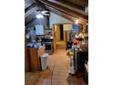 View of a rustic living room with exposed beams, wood floors, and an adjacent kitchen area at 4568 Apex Valley Rd, Golden, CO 80403
