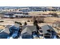 An aerial view of the house showcases its position within a neighborhood with open space and landscaping at 23612 Glenmoor Dr, Parker, CO 80138