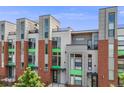 Modern townhouse showcasing clean lines, a brick facade, and upper-level outdoor balconies and rooftop terrace at 3008 Blake St, Denver, CO 80205