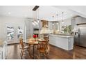 Bright eat-in kitchen featuring stainless steel appliances, shaker cabinets, and a beautiful breakfast nook at 6087 Highway 9, Breckenridge, CO 80424