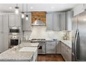 Modern kitchen featuring stainless steel appliances, white subway tile backsplash, and stylish granite countertops at 6087 Highway 9, Breckenridge, CO 80424