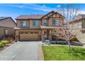 Inviting two-story home with a two-car garage and well-maintained landscaping at 12678 Fisher Ln, Englewood, CO 80112