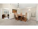 Dining area featuring a wooden table and unique, upholstered chairs under vaulted ceiling at 8643 Gold Peak Dr # E, Highlands Ranch, CO 80130