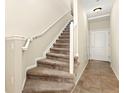 Carpeted staircase with white railing, leading to the upper level of the home at 8643 Gold Peak Dr # E, Highlands Ranch, CO 80130