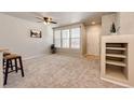 Bright living space featuring large windows, neutral decor and built-in shelving at 6745 S Winnipeg Cir # 103, Aurora, CO 80016