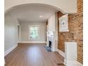Bright living room features exposed brick, white trim, a fireplace, and an open design at 575 N Marion St, Denver, CO 80218