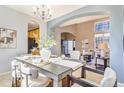 Beautiful dining area featuring a chandelier, sleek table setting, and arched entryway at 10935 Acadia, Parker, CO 80138