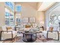 Inviting living room showcases large windows, stylish furniture, and a sophisticated color scheme at 10935 Acadia, Parker, CO 80138
