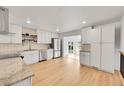 Modern kitchen featuring white cabinets, stainless steel appliances, and granite countertops at 6498 S Everett Way, Littleton, CO 80123