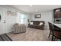 Comfortable living room showcasing neutral walls, wood floors, and natural light from large window at 4360 S Braun Ct, Morrison, CO 80465