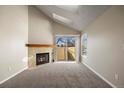 Living room with fireplace and patio access at 8690 Allison St # H, Arvada, CO 80005