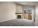 Living room with fireplace and sliding glass doors at 8690 Allison St # H, Arvada, CO 80005