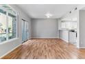 Bright living room with hardwood floors, sliding glass doors to balcony, and a kitchen bar at 2575 S Syracuse Way # 101, Denver, CO 80231