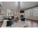 Bright living room features fireplace, high ceilings, modern fixtures, and comfortable seating at 10523 Ashfield St # 5C, Highlands Ranch, CO 80126
