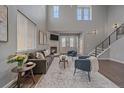 Inviting living room featuring a cozy fireplace, natural light, and a comfortable seating arrangement at 10523 Ashfield St # 5C, Highlands Ranch, CO 80126