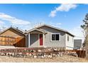 Charming house with gray siding and red front door at 316 Perry St, Denver, CO 80219