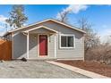 Gray house with red front door and landscaped yard at 316 Perry St, Denver, CO 80219