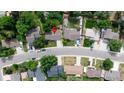 An aerial view shows the layout of a neighborhood with mature trees, sidewalks, and single-Gathering homes on generously sized lots at 6427 S Ingalls St, Littleton, CO 80123