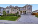 Charming two-story home with a well-manicured lawn, stone accents, and a cozy front porch at 6063 Eldora St, Golden, CO 80403