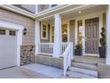 Inviting front porch with white columns, stone accents, and a freshly painted front door at 6063 Eldora St, Golden, CO 80403
