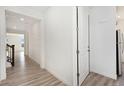 Bright hallway with hardwood floors leading to various rooms in the house at 5226 Inland Ave, Firestone, CO 80504