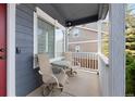 Small front porch with two wicker chairs and a small table at 3836 Garnet Way, Highlands Ranch, CO 80126