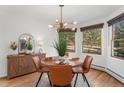 Bright dining room with a modern chandelier, a round table, and large windows at 4185 Red Rock Dr, Larkspur, CO 80118