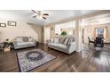 Inviting living room featuring neutral walls, hardwood floors, and comfortable sofas at 814 Pintail Ave, Brighton, CO 80601
