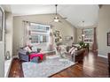 Sunlit living room featuring large windows, plush seating, and hardwood floors at 9603 Las Colinas Dr, Lone Tree, CO 80124