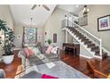 Open-concept living room featuring high ceilings, hardwood floors, and a staircase at 9603 Las Colinas Dr, Lone Tree, CO 80124
