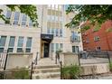 Charming building entrance with black awning, stone facade and lovely front patio at 340 S Lafayette St # 204, Denver, CO 80209
