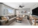 Bright living room with a large window, a comfy sectional sofa, and stylish decorations at 1432 Red Mica Way, Monument, CO 80132