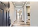 Inviting entryway featuring wood-look floors, tray ceilings, and an open floorplan at 6712 Sea Oats Dr, Parker, CO 80138