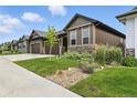 Exterior view of the house with a well-manicured lawn and beautiful landscaping at 6712 Sea Oats Dr, Parker, CO 80138