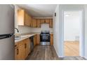 Well-lit kitchen featuring stainless steel appliances, wooden cabinets, and sleek countertops at 1900 Kingston St, Aurora, CO 80010