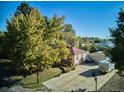 Aerial view of a single Gathering home with mature trees and RV parking on a sunny day at 7735 Westview Dr, Lakewood, CO 80214