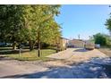 Well-maintained front yard with ample parking and mature trees at 7735 Westview Dr, Lakewood, CO 80214