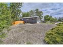 A spacious, fully fenced backyard with well-maintained gravel and foliage ensures privacy at 10472 Lincoln Ct, Northglenn, CO 80233