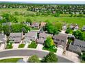 An aerial view of a residential neighborhood with well-maintained lawns and mature trees at 2011 Sundrop Trl, Highlands Ranch, CO 80126